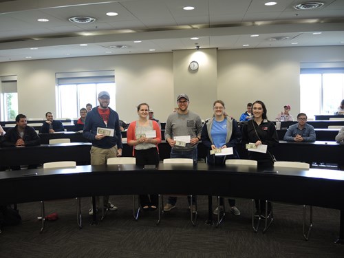 Students holding their certificates