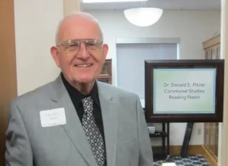 Dr. Donald Pitzer stands outside USI's Communal Studies Reading Room