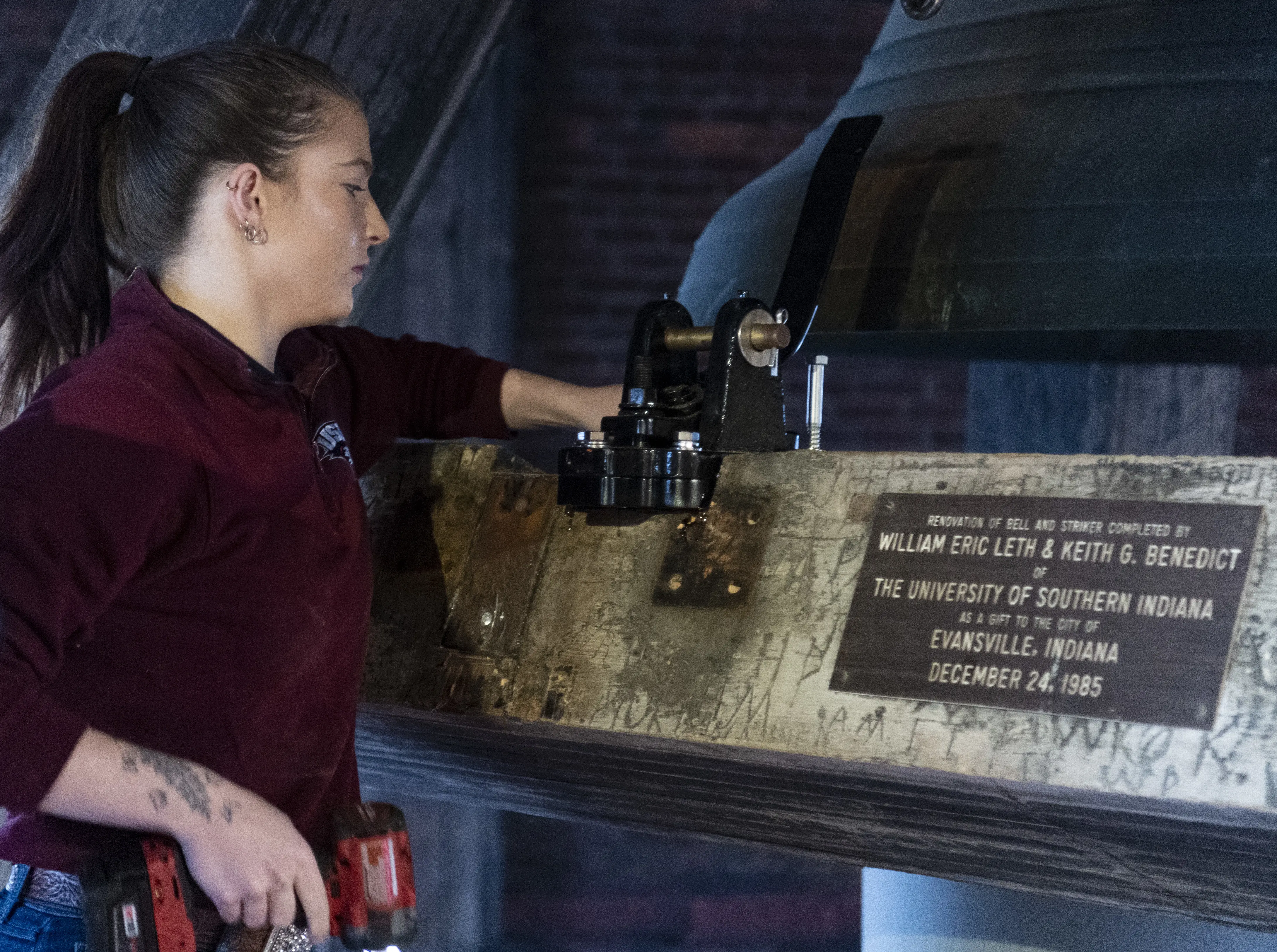 USI student works on the striker shelf marked by a plaque honoring the previous work USI completed for the bell in December 1985.
