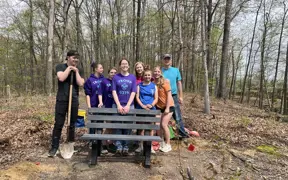 A Scouting Troop helps a fellow 2025 Eagle Scout install some benches on Bent Twig Trail. 