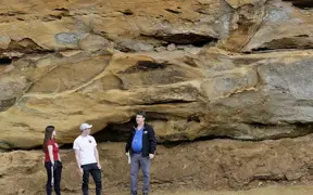 Geology students looking at the sandstone bluffs located on the south eastern side of campus.