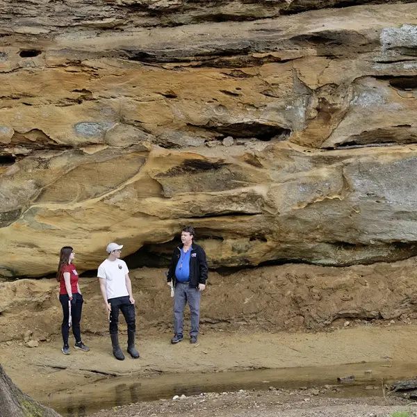 Geology students looking at the sandstone bluffs located on the south eastern side of campus.