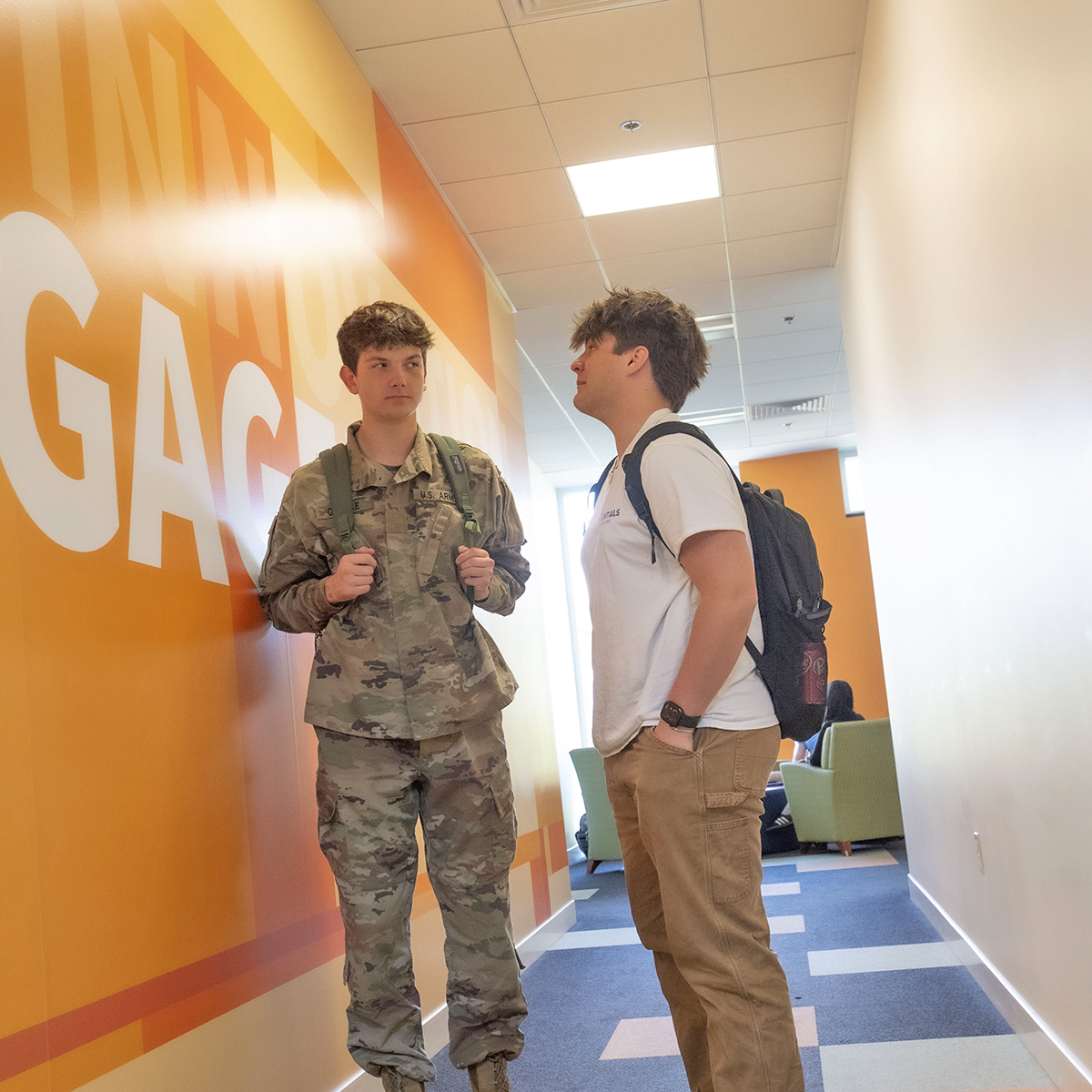 An ROTC student in the Business Engineering students stops to talk to a friend between classes.