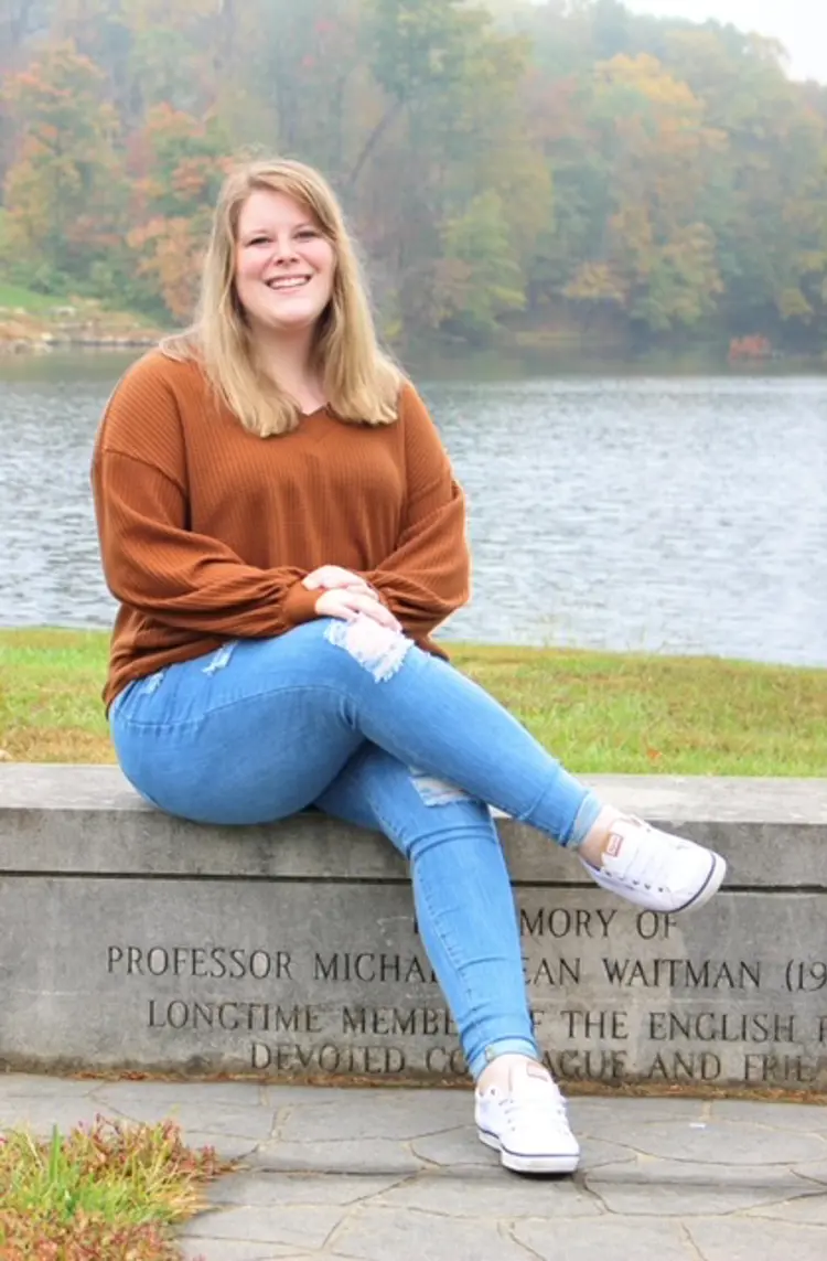 Casual portrait of Hope Baker '20, English major, sitting near a lake