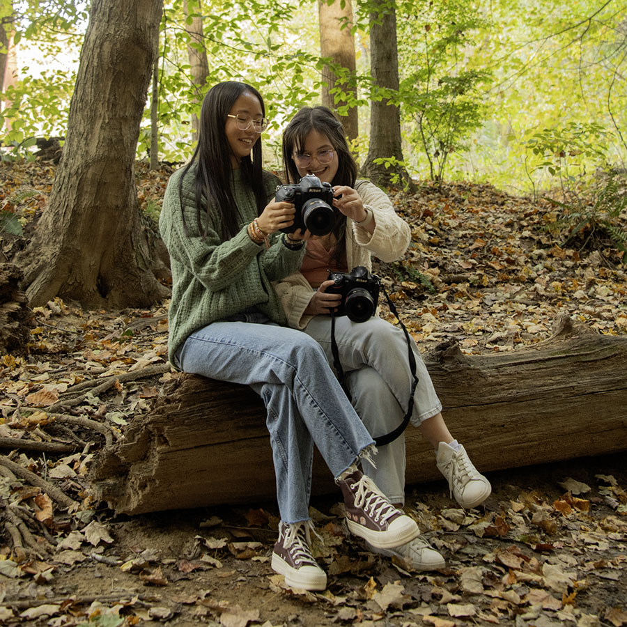 Photography students admire each other's nature photos on the USI Trails. 