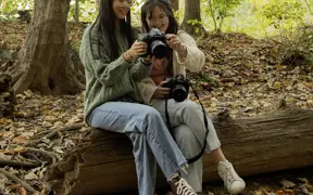 Photography students admire each other's nature photos on the USI Trails. 