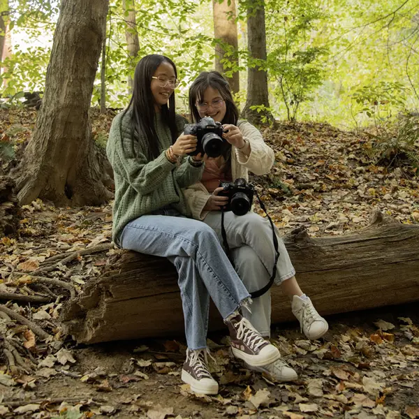 Photography students admire each other's nature photos on the USI Trails. 