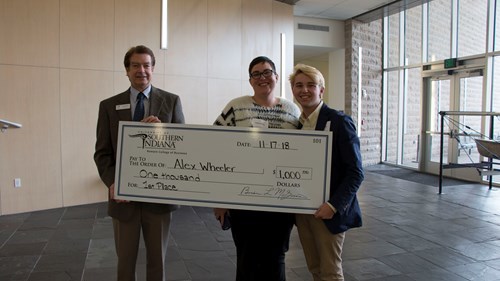 McGuire, HC Counselor, and Alex holding check