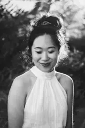 Amie Whittemore standing by a pond in the woods