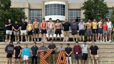 group image of Kappa Alpha fraternity members in front of Rice Library