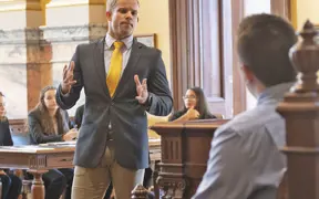 A prelaw student cross examines a witness during a mock trial held at a historic court house. 