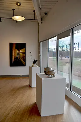 Photo of artworks: a painting of a hallway, ceramic bowls, and a small sculpture