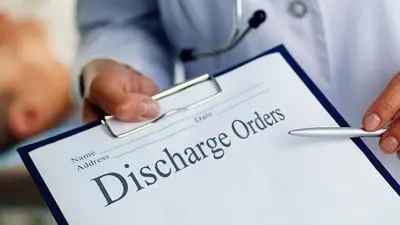 Person pointing to clipboard with words "discharge orders"