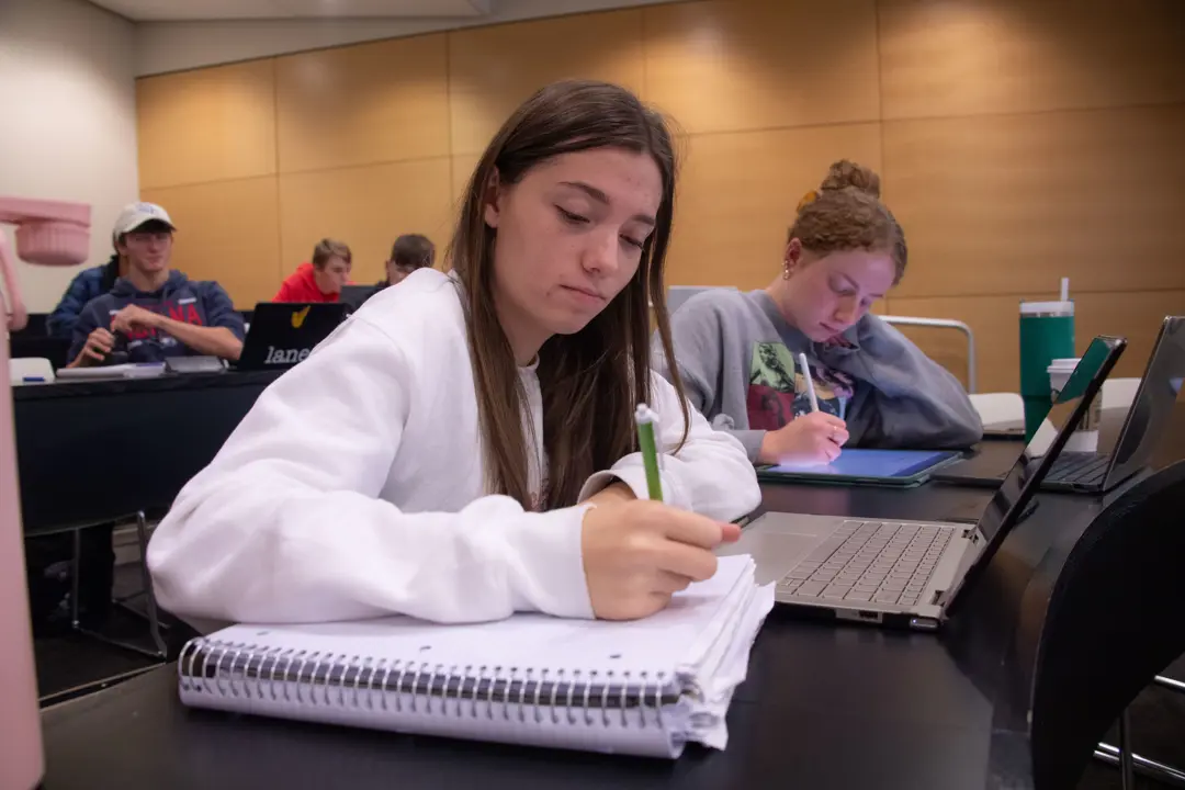 A student works on accounting schoolwork. 