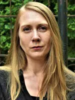 Amie Whittemore standing by a pond in the woods