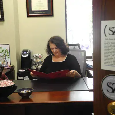 Image of Susan Todd at desk with folder