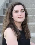 Amie Whittemore standing by a pond in the woods