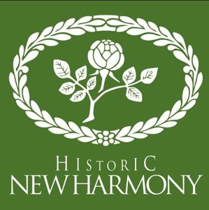 Green square logo featuring a white floral emblem surrounded by a wreath, with the text “Historic New Harmony” below.