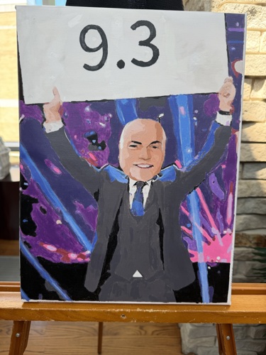 Painting of President Bridges' face on a game show judge's body holding up a sing with a score of 9.3