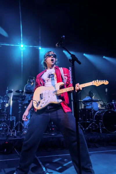 Ross Lynch on stage with a guitar.
