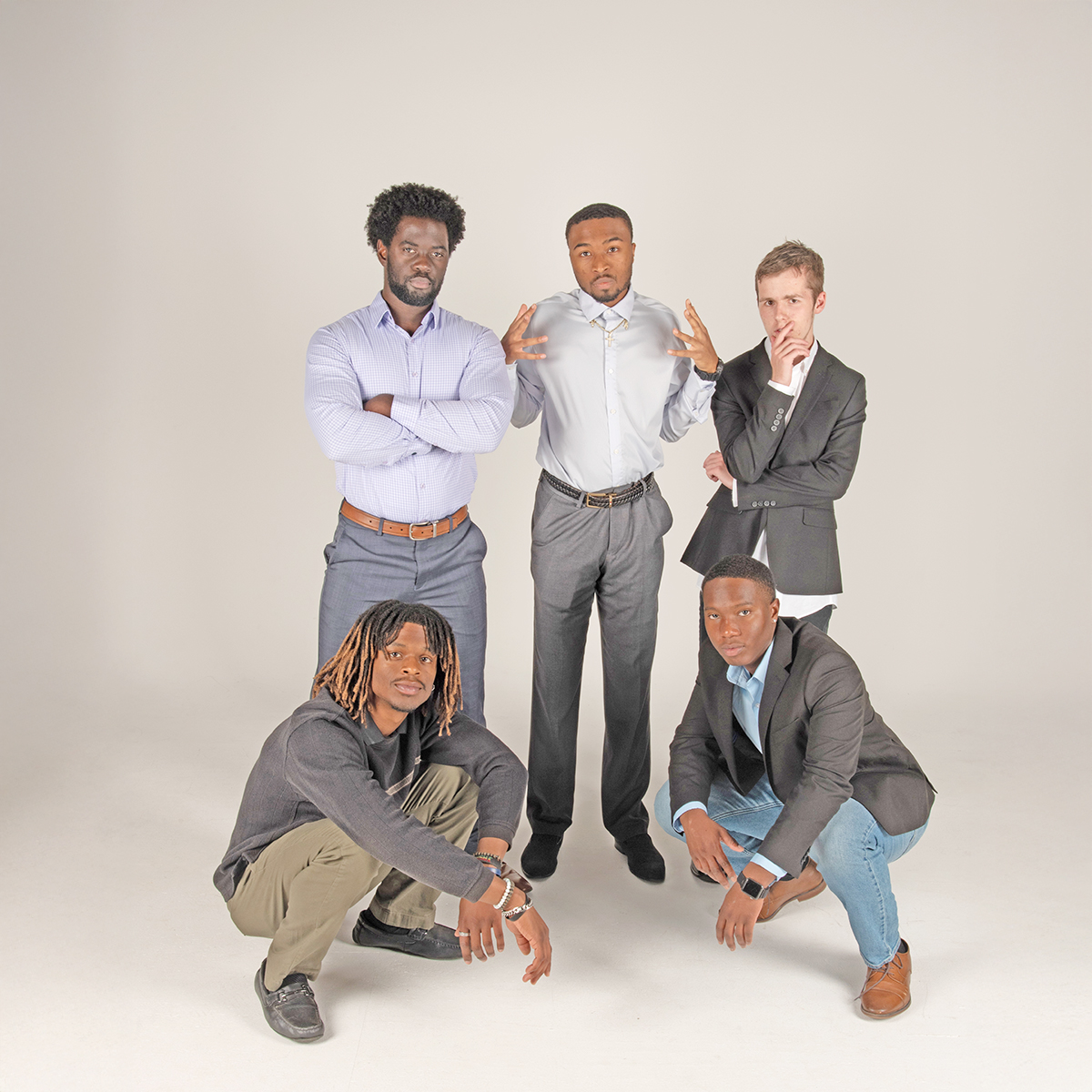 Five members of the Collegiate Men of Distinction strike a pose in the photo studio