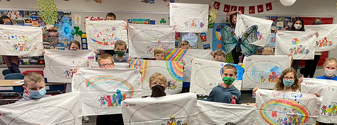 Students holding decorated pillowcases
