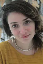 Amie Whittemore standing by a pond in the woods