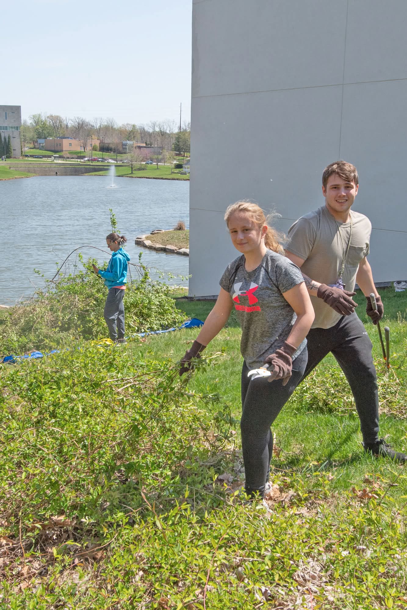 Students pull invasive Japanese Honeysuckle from the Bent Twig Trails at the 2nd Trail Clean Up Weed Wrangle at USI. 