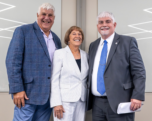 Dave Coudret and Nadine Coudret pose for a photo with USI President Steve Bridges