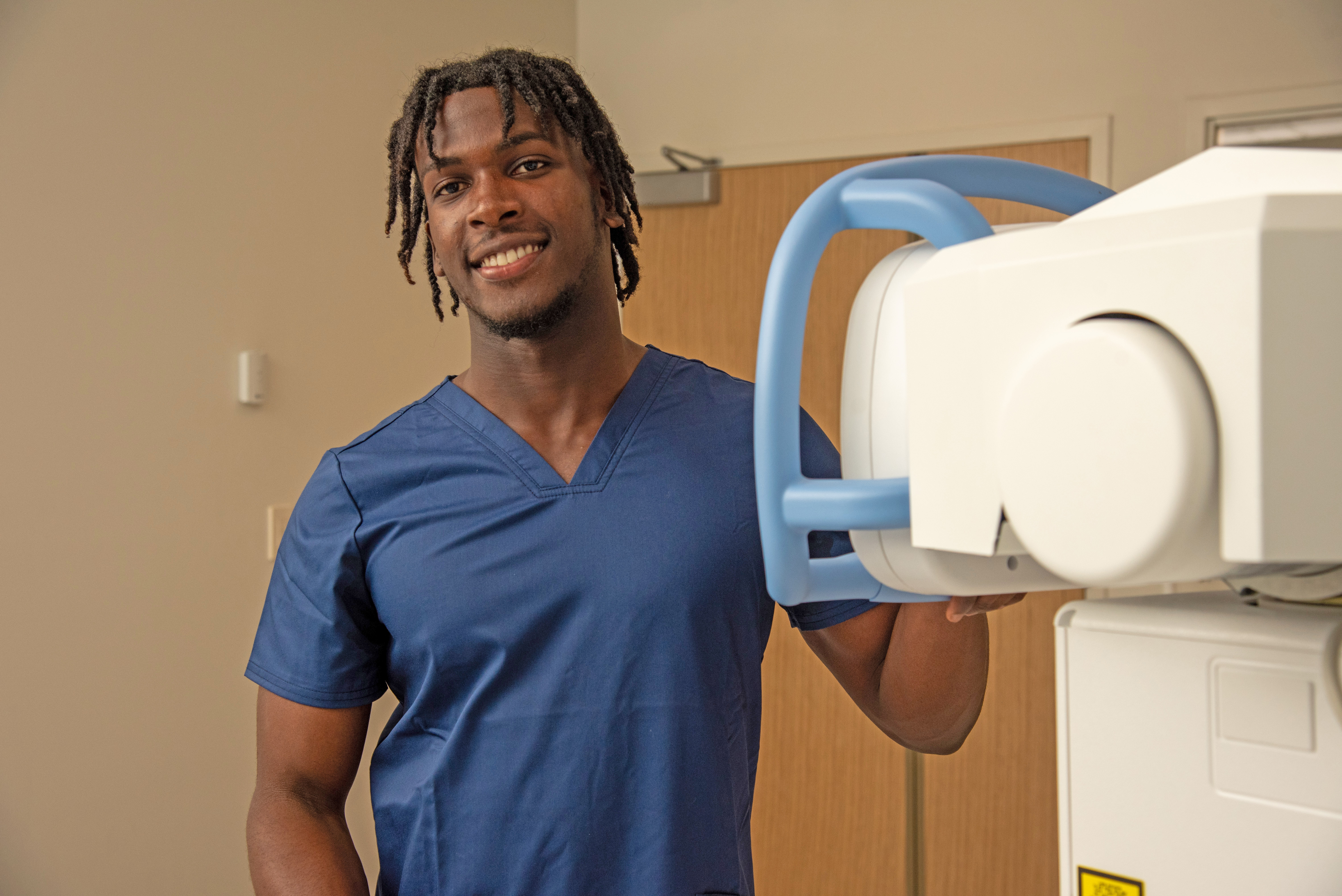 Radiology student in the front of new radiology equipment