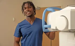 Radiology student in the front of new radiology equipment