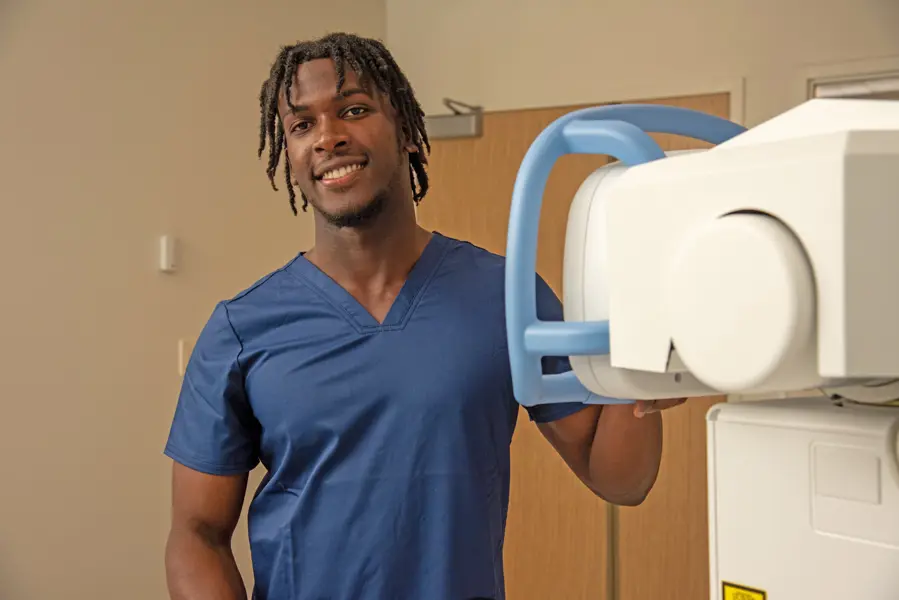 Radiology student in the front of new radiology equipment