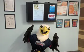 Archie underneath a TV monitor that has nutrition information on the screen