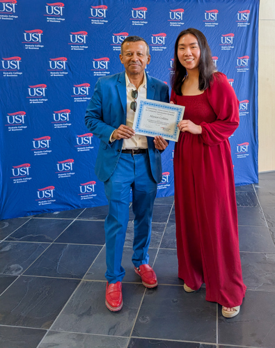 Dean handing Alyson a certificate