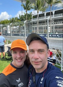 Ashley and spouse at racing event