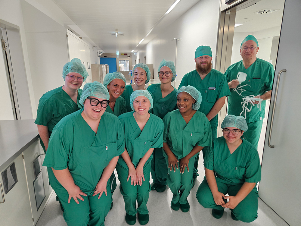 Healthcare students wearing green scrubs at hospital in Germany