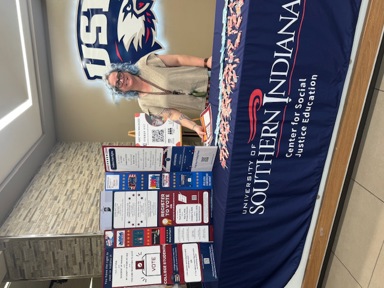 CSJE volunteer provides information about registering to vote in upcoming elections