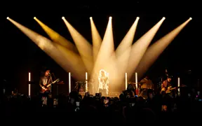 The Driver Era on stage with spotlights highlighting Ross Lynch in the center.