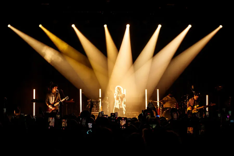 The Driver Era on stage with spotlights highlighting Ross Lynch in the center.
