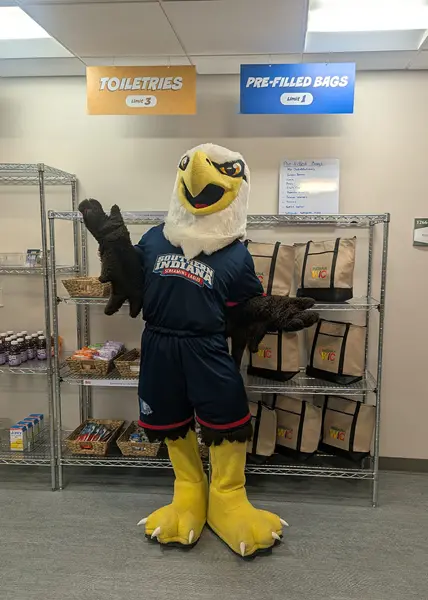 Archie standing in front of pre-filled bags of food