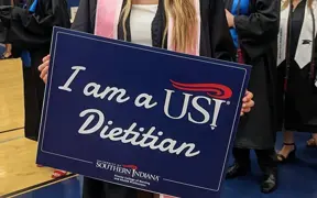 Student holding a dietitian sign