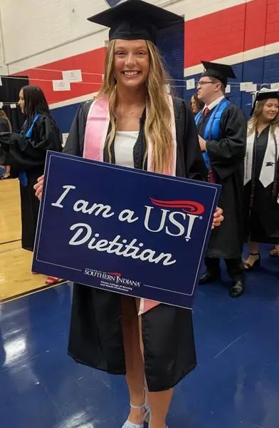 Student holding a dietitian sign