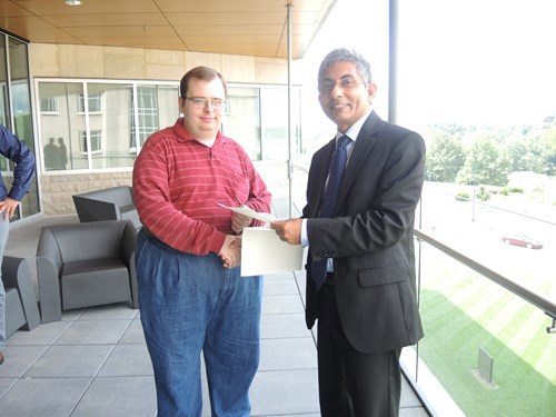 Dean giving Matthew a certificate