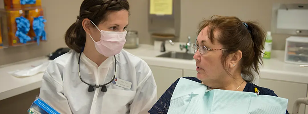 Photo of faculty member and patient in lab