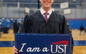 Student holding dietian sign