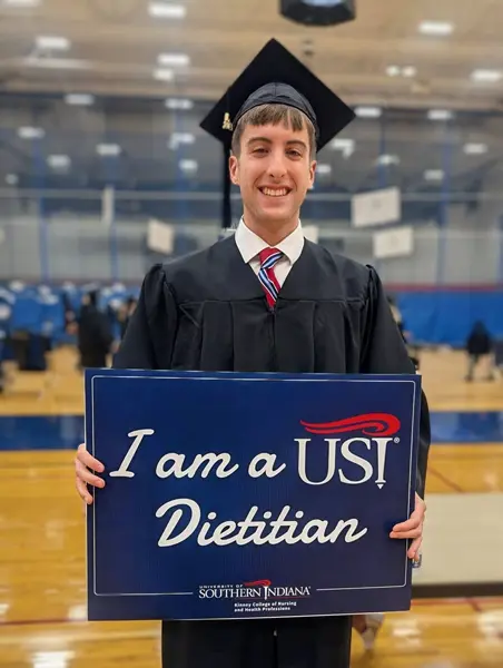Student holding dietian sign