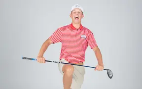 A member of USI's men's golf team pretends to yell and break his club across his knee for his media day photo.