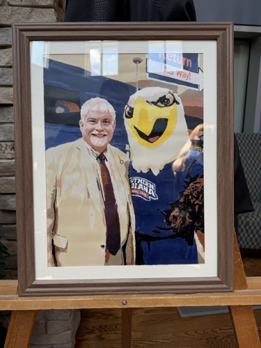 Painting of President Bridges smiling with Archie Eagle