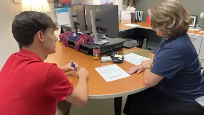 A career counselor in the Career Success Center gives a student feedback on his resume