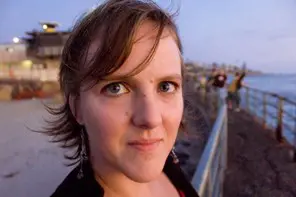 Amie Whittemore standing by a pond in the woods